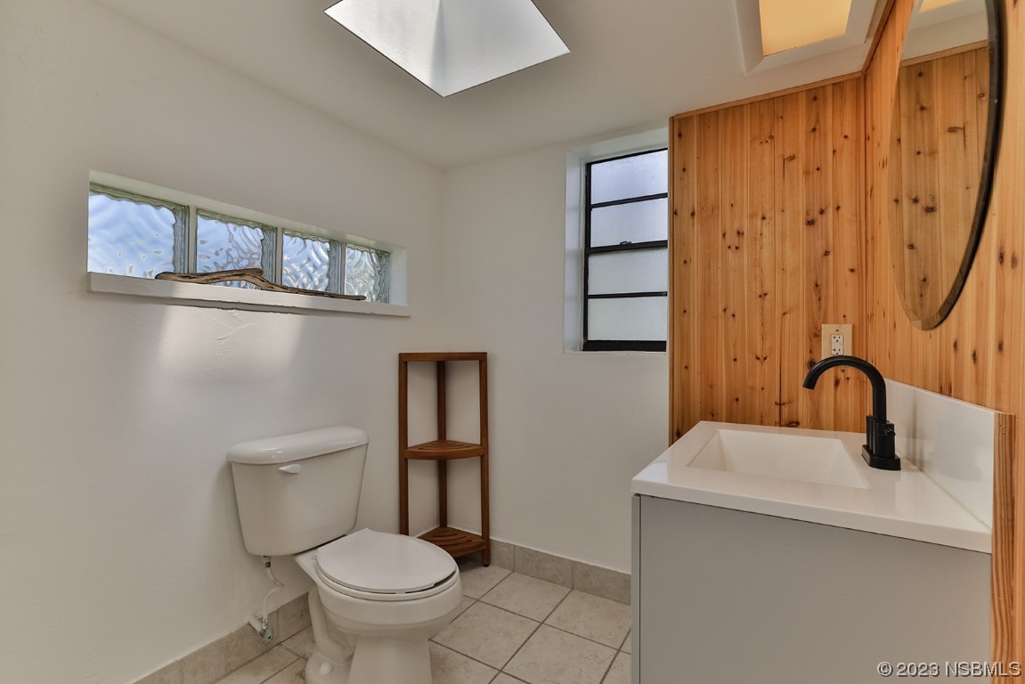 133 Milton Road Daytona Beach, FL 32118 - Photo 50 of 70 a bathroom with a toilet sink and mirror