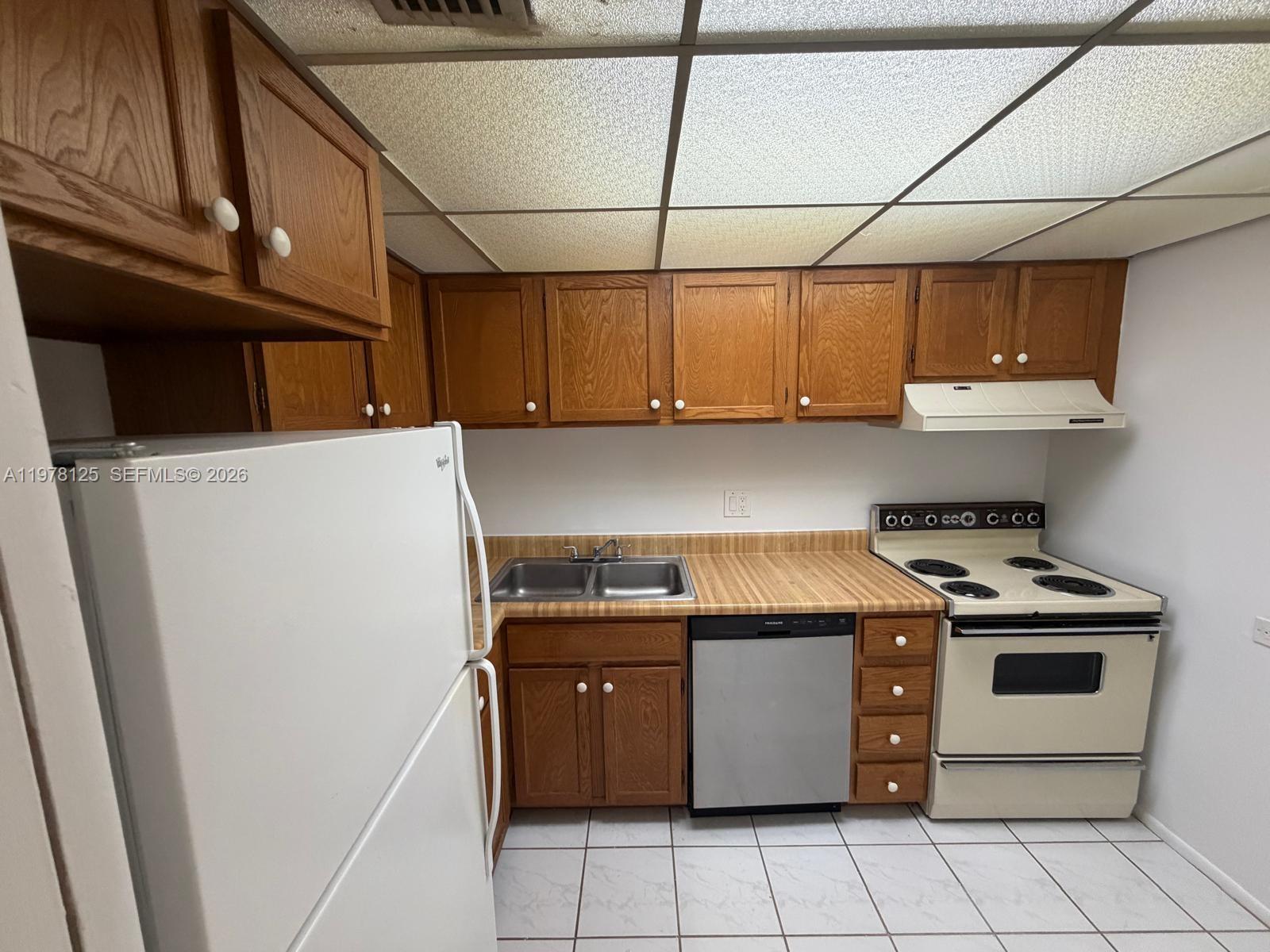 a kitchen with a stove and a refrigerator