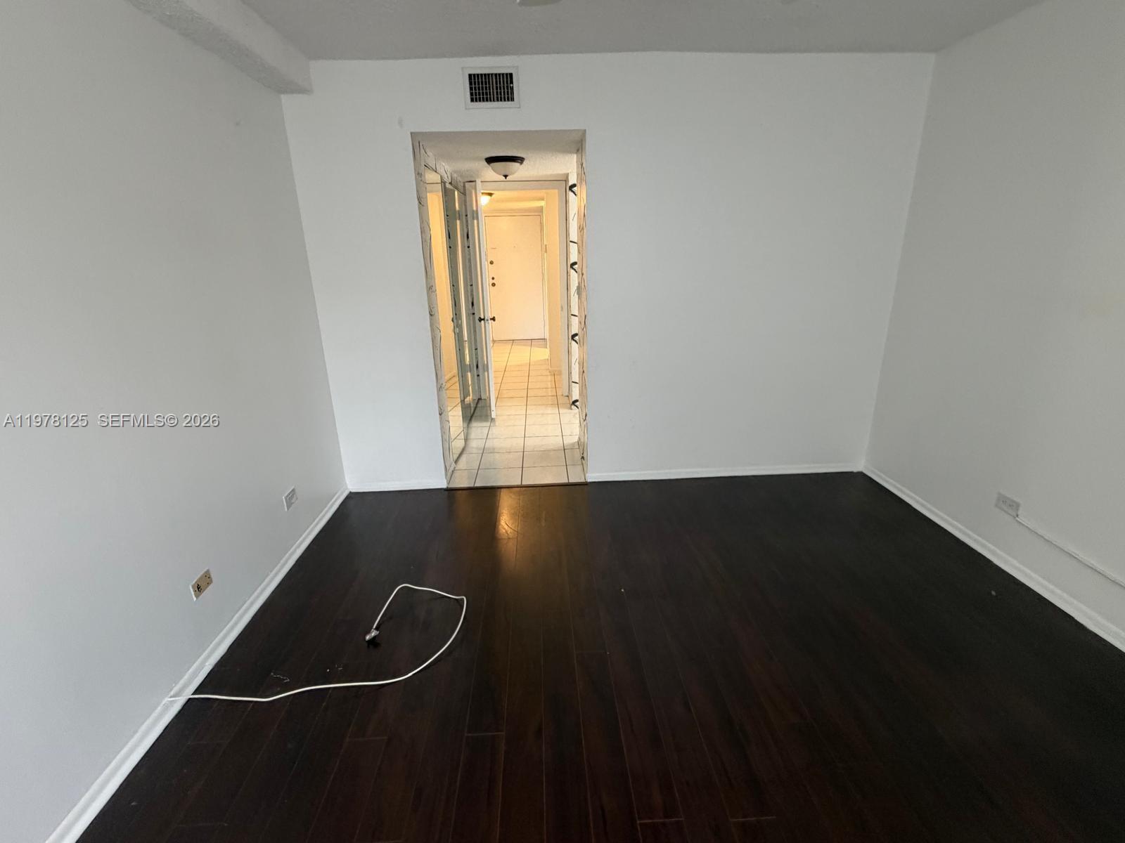 3720 Inverrary Drive, Unit 2K Lauderhill, FL 33319 - Photo 13 of 15 an empty room with wooden floor and windows