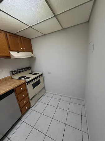 a kitchen with stainless steel appliances a stove a sink and cabinets