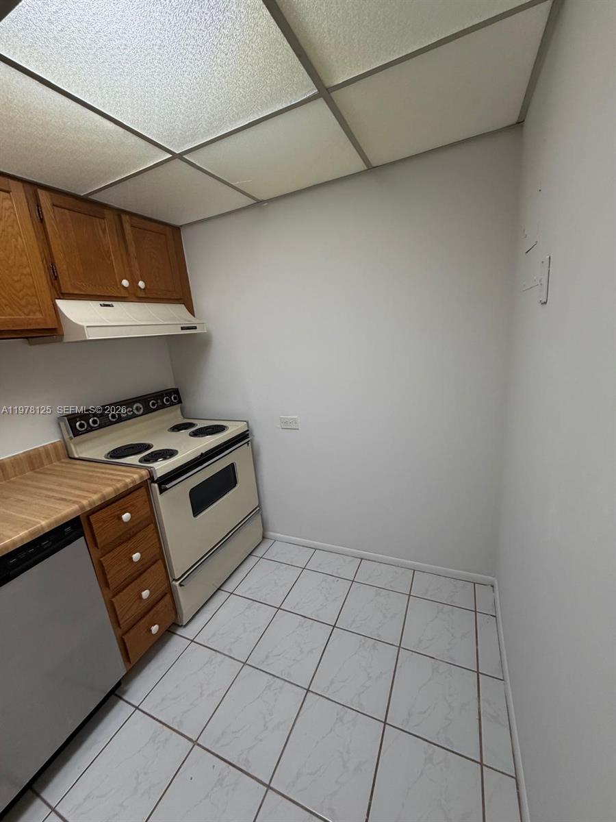 3720 Inverrary Drive, Unit 2K Lauderhill, FL 33319 - Photo 4 of 15 a kitchen with stainless steel appliances a stove a sink and cabinets