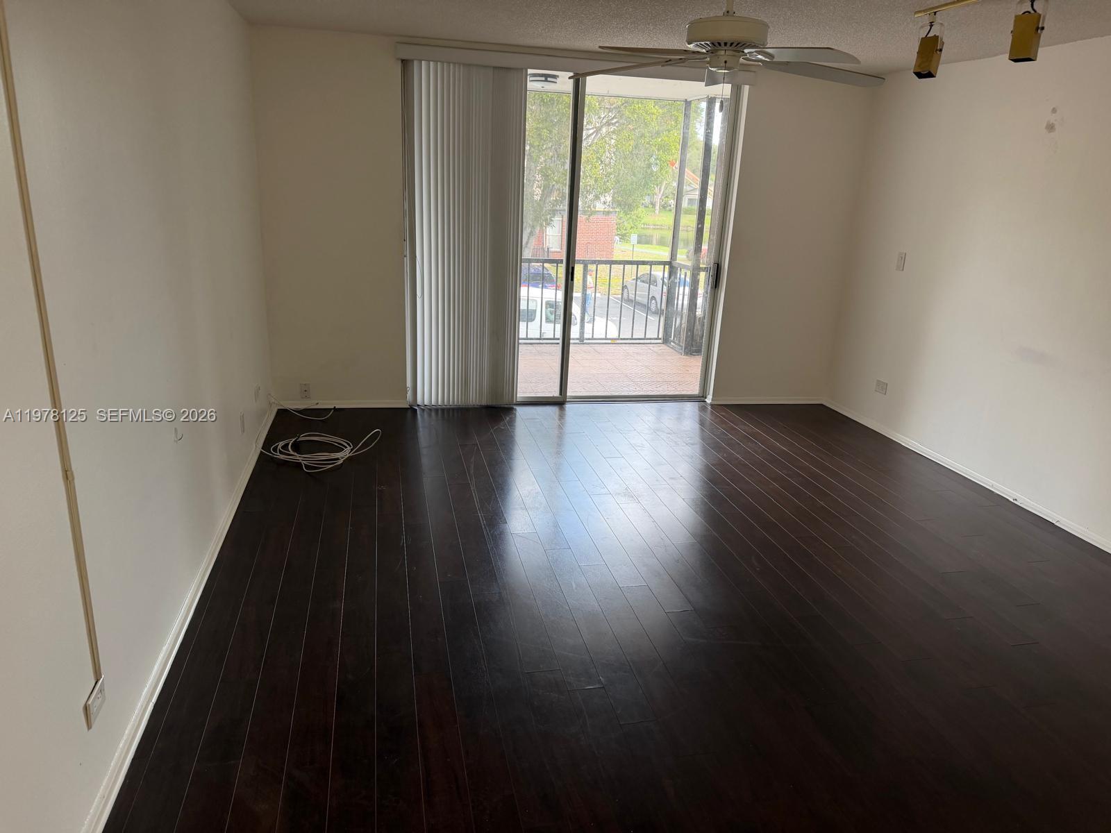 3720 Inverrary Drive, Unit 2K Lauderhill, FL 33319 - Photo 8 of 15 an empty room with wooden floor and windows