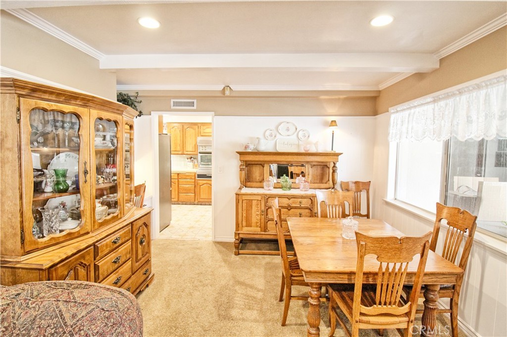 1203 Hidden Springs Lane Glendora, CA 91741 - Photo 17 of 47 a view of a dining room with furniture next to a window and a kitchen view
