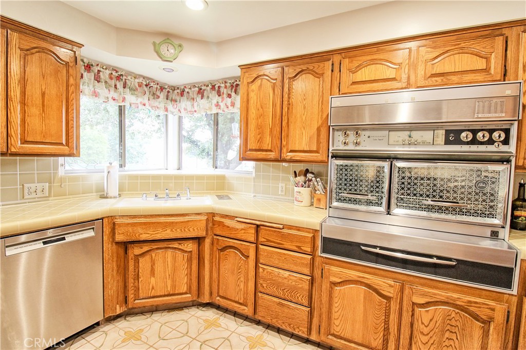 1203 Hidden Springs Lane Glendora, CA 91741 - Photo 20 of 47 a kitchen with stainless steel appliances granite countertop a sink and cabinets