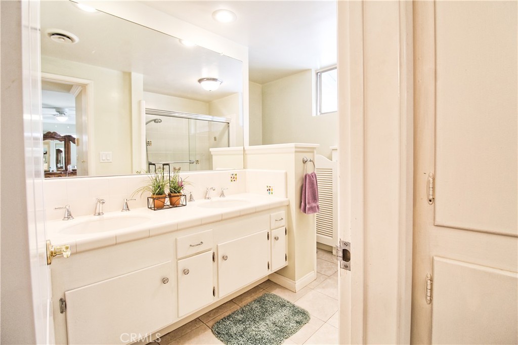 1203 Hidden Springs Lane Glendora, CA 91741 - Photo 30 of 47 a bathroom with a double vanity sink and mirror