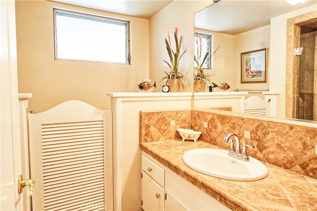 1203 Hidden Springs Lane Glendora, CA 91741 - Photo 39 of 47 a bathroom with a granite countertop sink and a mirror
