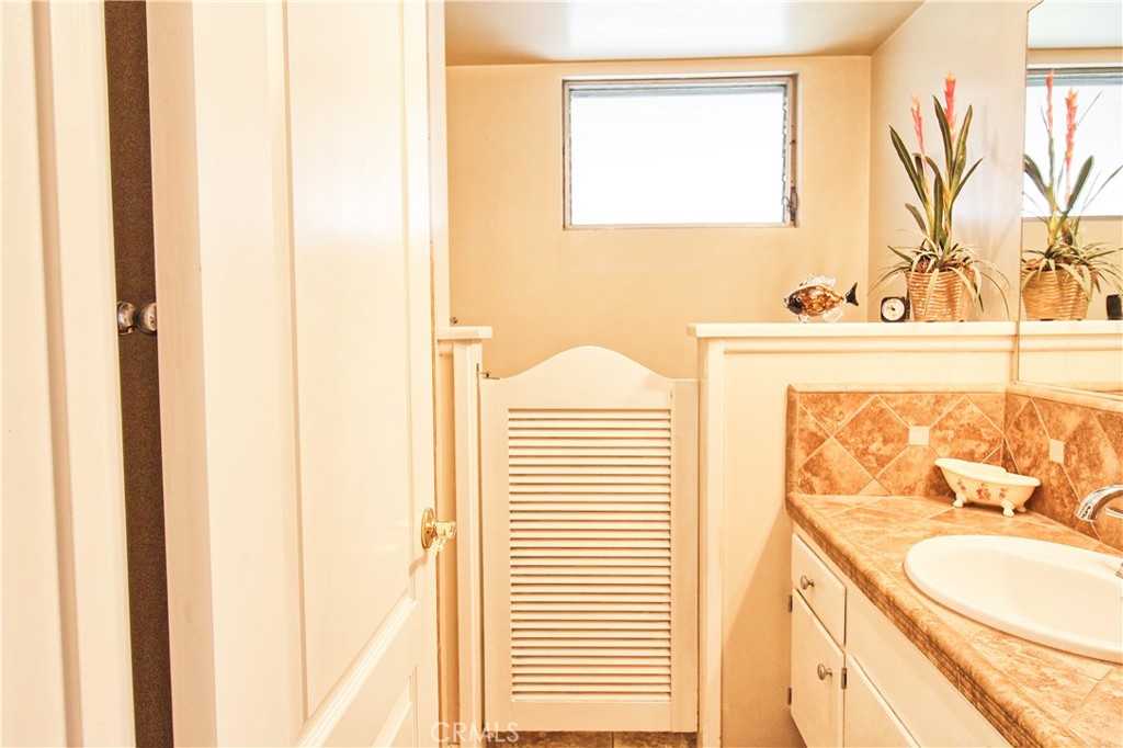 1203 Hidden Springs Lane Glendora, CA 91741 - Photo 40 of 47 a bathroom with a sink and a mirror