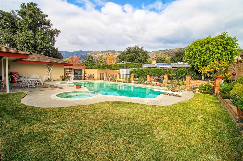 1203 Hidden Springs Lane Glendora, CA 91741 - Photo 43 of 47 a view of a swimming pool with an outdoor space and seating area