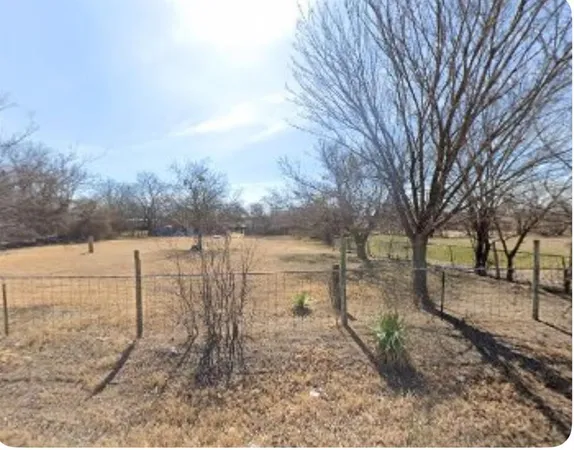 a view of a lake with a yard