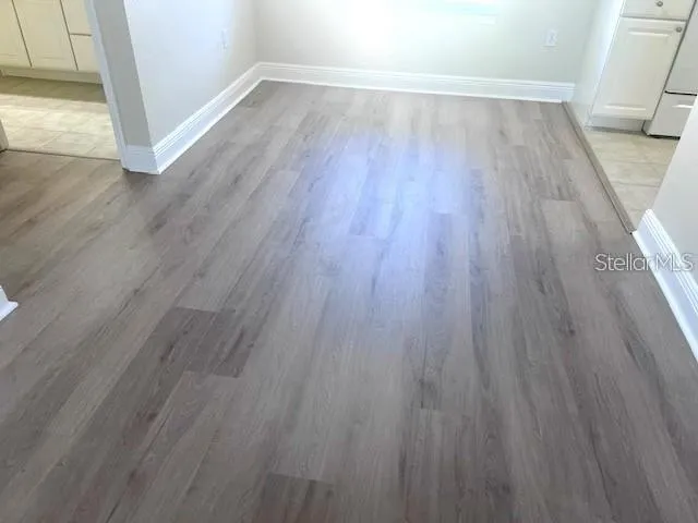 a kitchen with wooden floors white cabinets and wooden floor