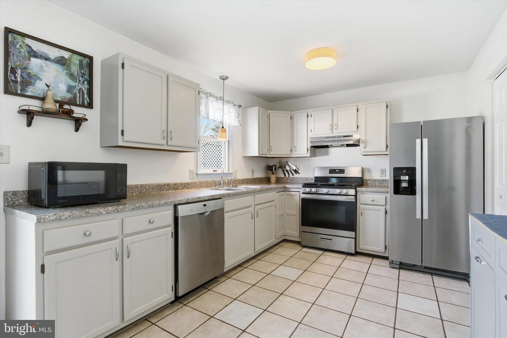 794 Barrett Street Hanover, PA 17331 - Photo 7 of 22 a kitchen with white cabinets and appliances