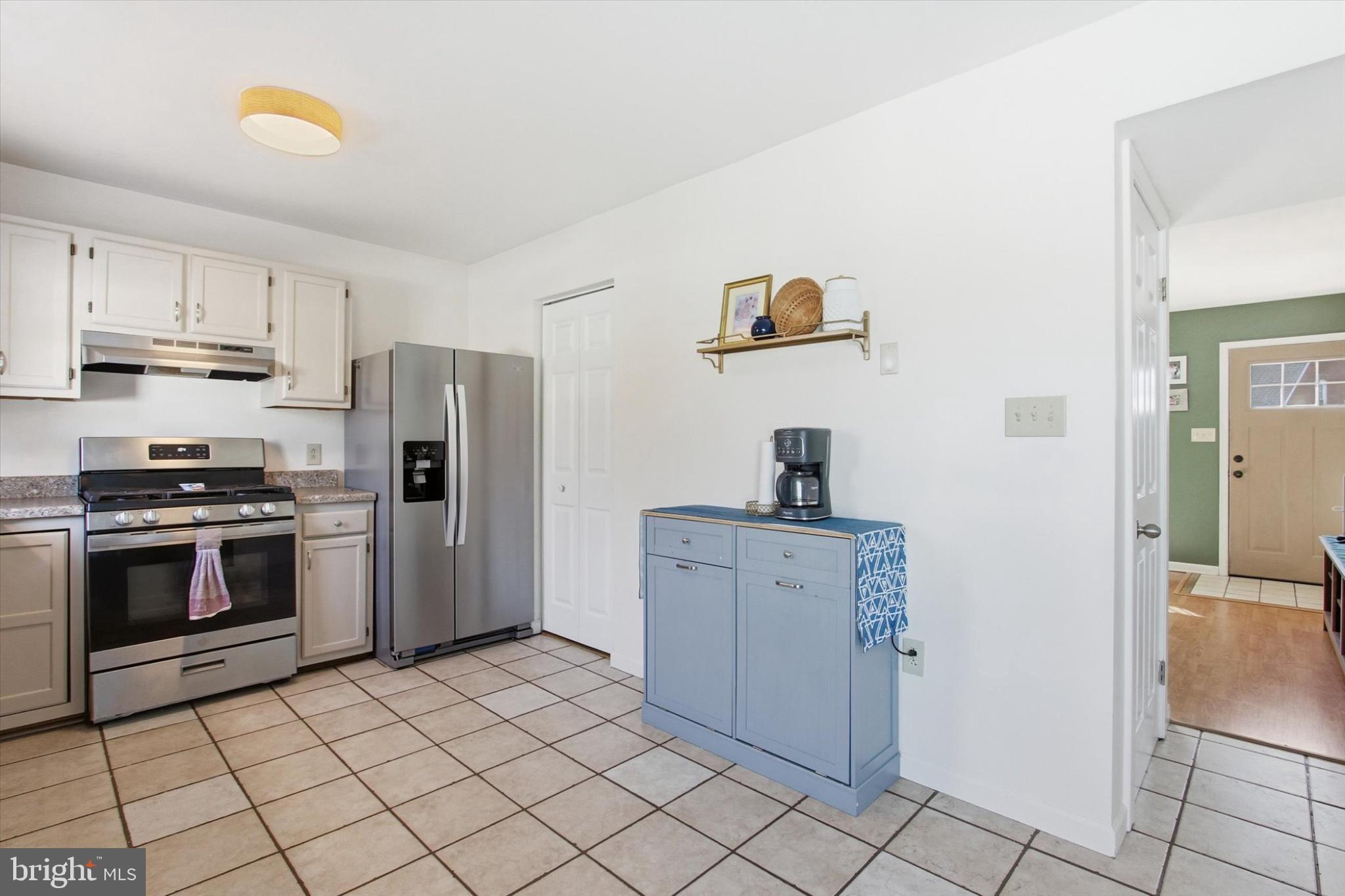 794 Barrett Street Hanover, PA 17331 - Photo 8 of 22 a kitchen with a refrigerator and a stove top oven