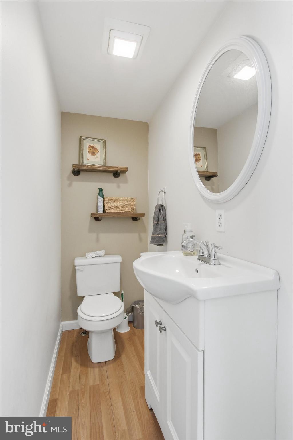 794 Barrett Street Hanover, PA 17331 - Photo 10 of 22 a bathroom with a toilet a sink and a mirror