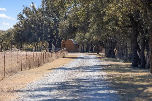 a view of a yard with wooden fence