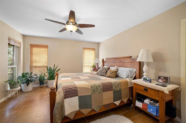 a bedroom with bed and a potted plant