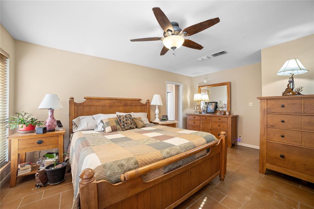 451 County Road 423 May, TX 76857 - Photo 23 of 40 a bedroom with a bed and wooden floors