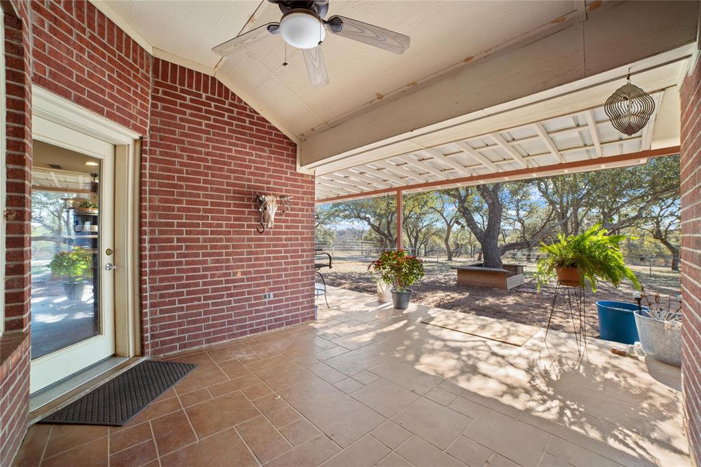 451 County Road 423 May, TX 76857 - Photo 28 of 40 a view of a porch with a table and chairs and floor to ceiling window