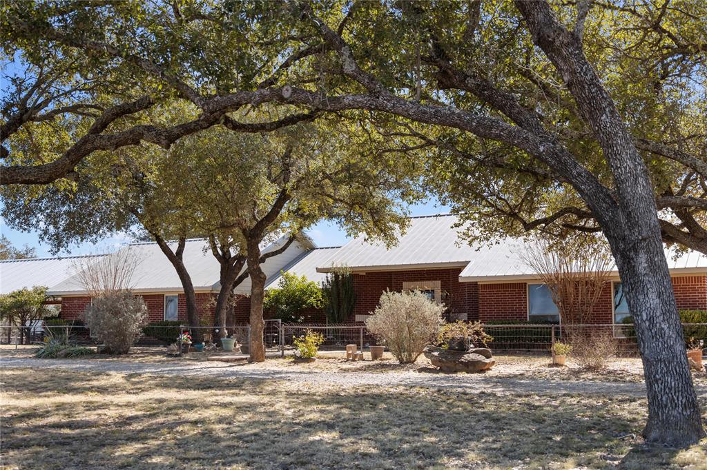 451 County Road 423 May, TX 76857 - Photo 4 of 40 a view of a house with a tree in the yard