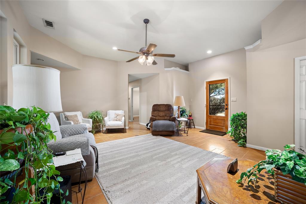 451 County Road 423 May, TX 76857 - Photo 9 of 40 a bedroom with furniture and a chandelier