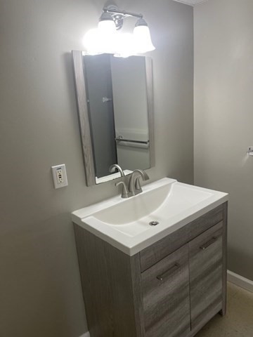 72 Elmore Street Holyoke, MA 01040 - Photo 15 of 28 a bathroom with a sink vanity and a mirror