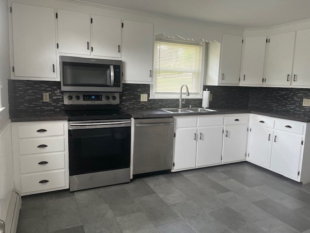 72 Elmore Street Holyoke, MA 01040 - Photo 2 of 28 a kitchen with granite countertop white cabinets and appliances
