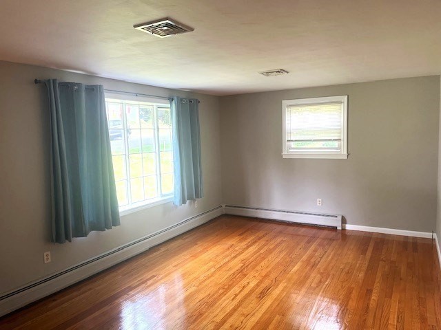 72 Elmore Street Holyoke, MA 01040 - Photo 4 of 28 a view of an empty room with wooden floor and a window