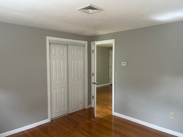 72 Elmore Street Holyoke, MA 01040 - Photo 5 of 28 an empty room with wooden floor closet and windows
