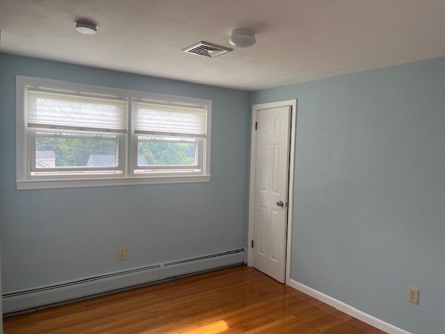 72 Elmore Street Holyoke, MA 01040 - Photo 8 of 28 an empty room with wooden floor and windows