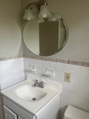 72 Elmore Street Holyoke, MA 01040 - Photo 10 of 28 a bathroom with a sink and mirror