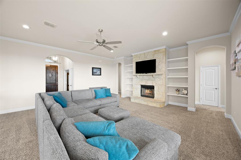 2618 Byrd Ranch Road Midlothian, TX 76065 - Photo 10 of 38 a living room with furniture a fireplace and a flat screen tv