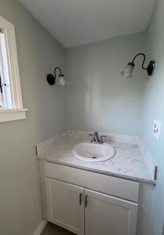 a bathroom with a sink and vanity