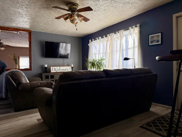 a living room with furniture and a flat screen tv