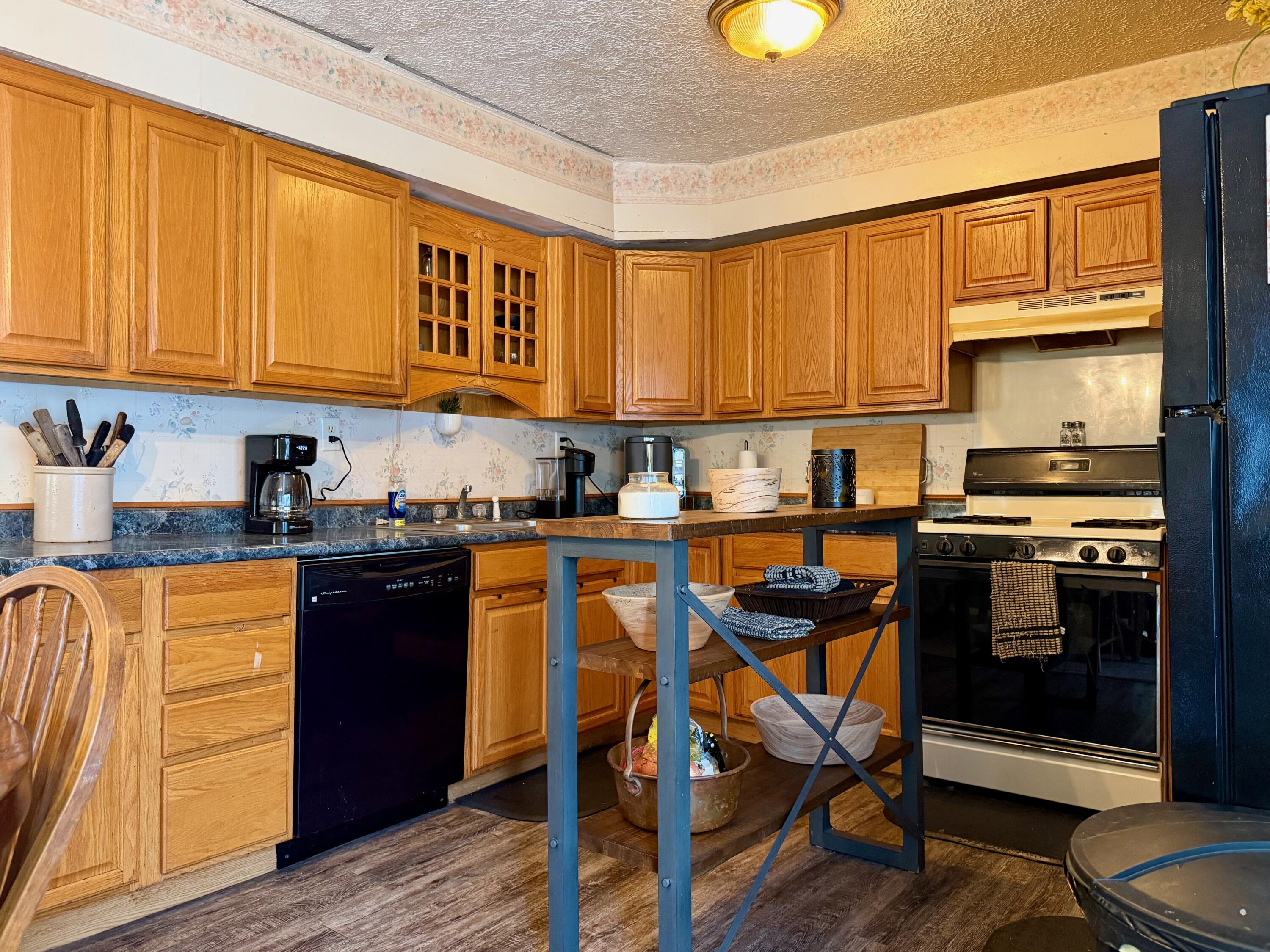 109 South Jefferson Street Hamlet, IN 46532 - Photo 6 of 14 a kitchen with stainless steel appliances granite countertop sink stove top oven and cabinets