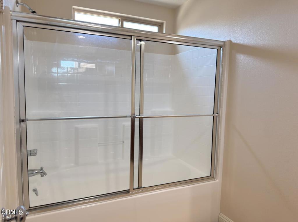 433 Merced Court Corona, CA 92878 - Photo 13 of 22 a bathroom with a glass shower door