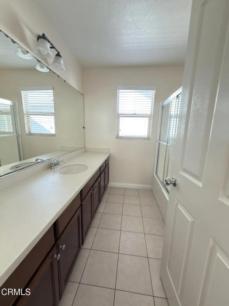 433 Merced Court Corona, CA 92878 - Photo 14 of 22 a kitchen with a sink a refrigerator and window