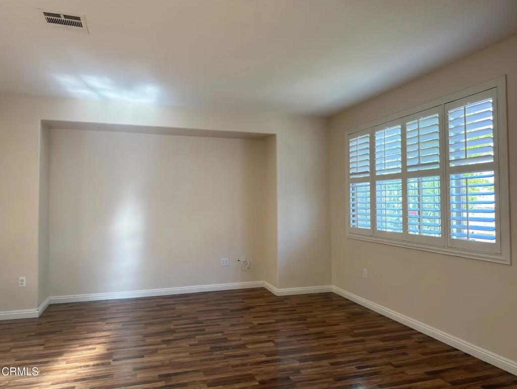 433 Merced Court Corona, CA 92878 - Photo 4 of 22 a view of an empty room with wooden floor and a window