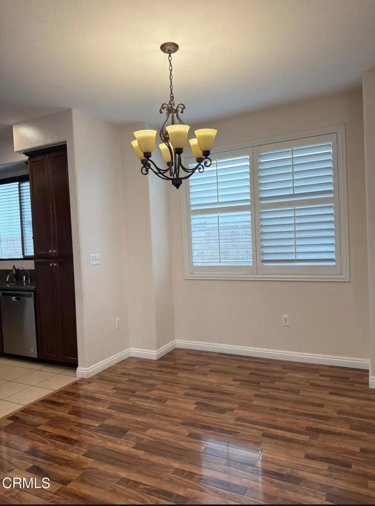 433 Merced Court Corona, CA 92878 - Photo 5 of 22 a view of a room with wooden floor and chandelier