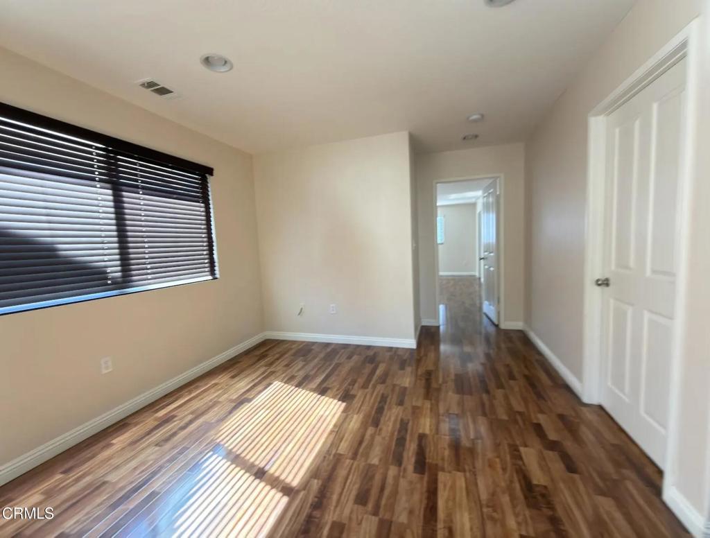 433 Merced Court Corona, CA 92878 - Photo 7 of 22 a view of a room with wooden floor and a window