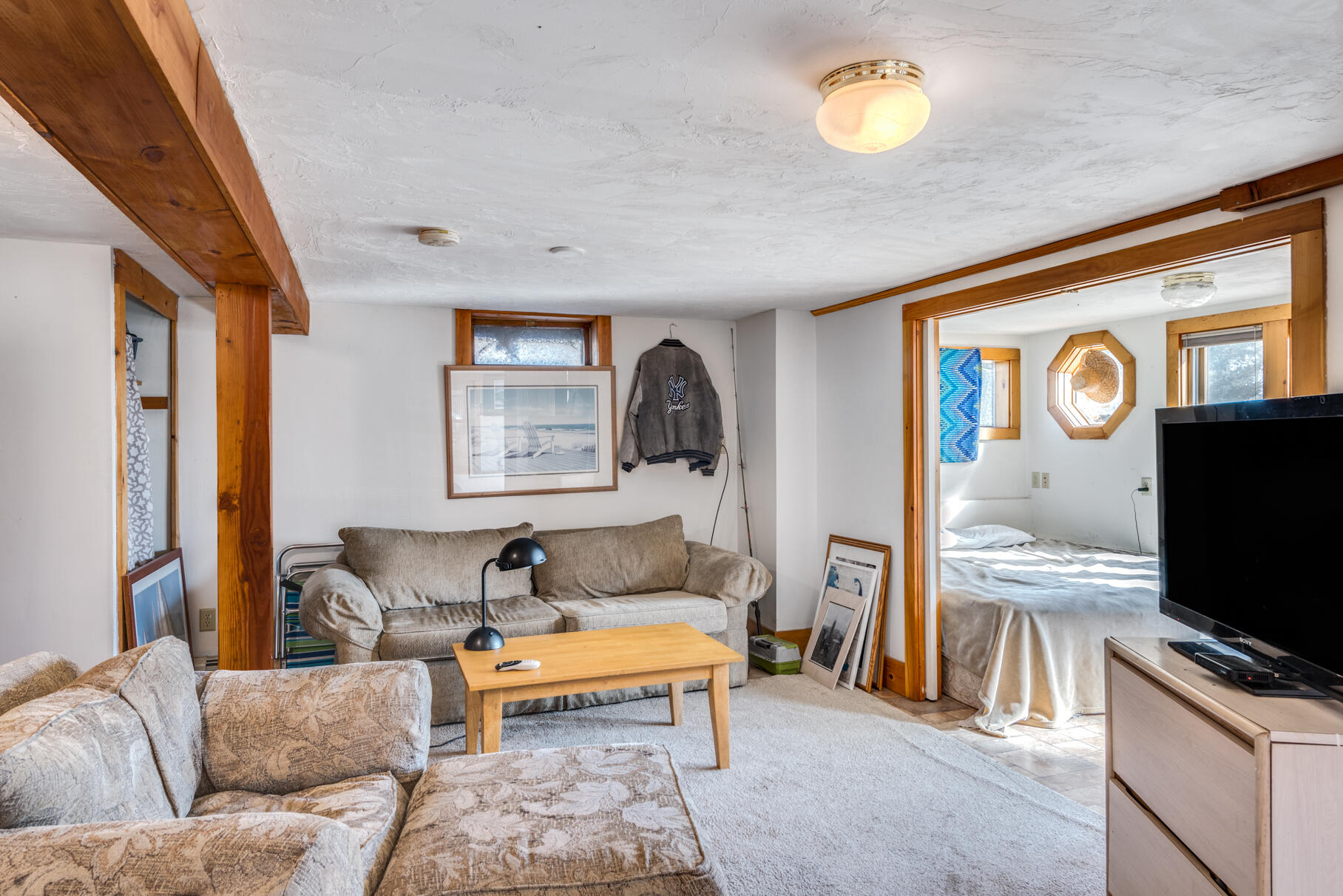 704 State Highway Eastham, MA 02642 - Photo 14 of 26 a living room with furniture and a flat screen tv