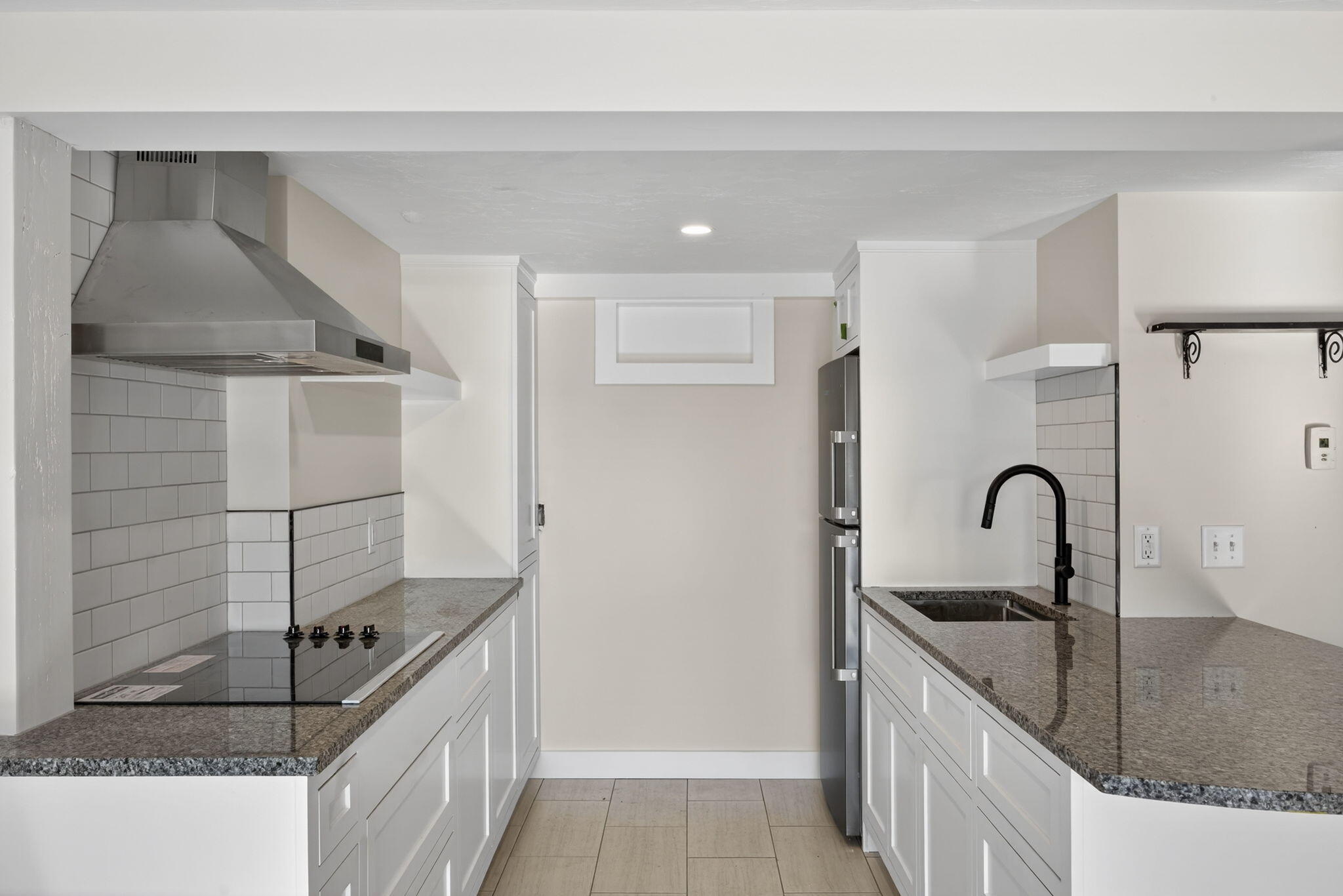 704 State Highway Eastham, MA 02642 - Photo 15 of 26 a kitchen with kitchen island a sink appliances and cabinets