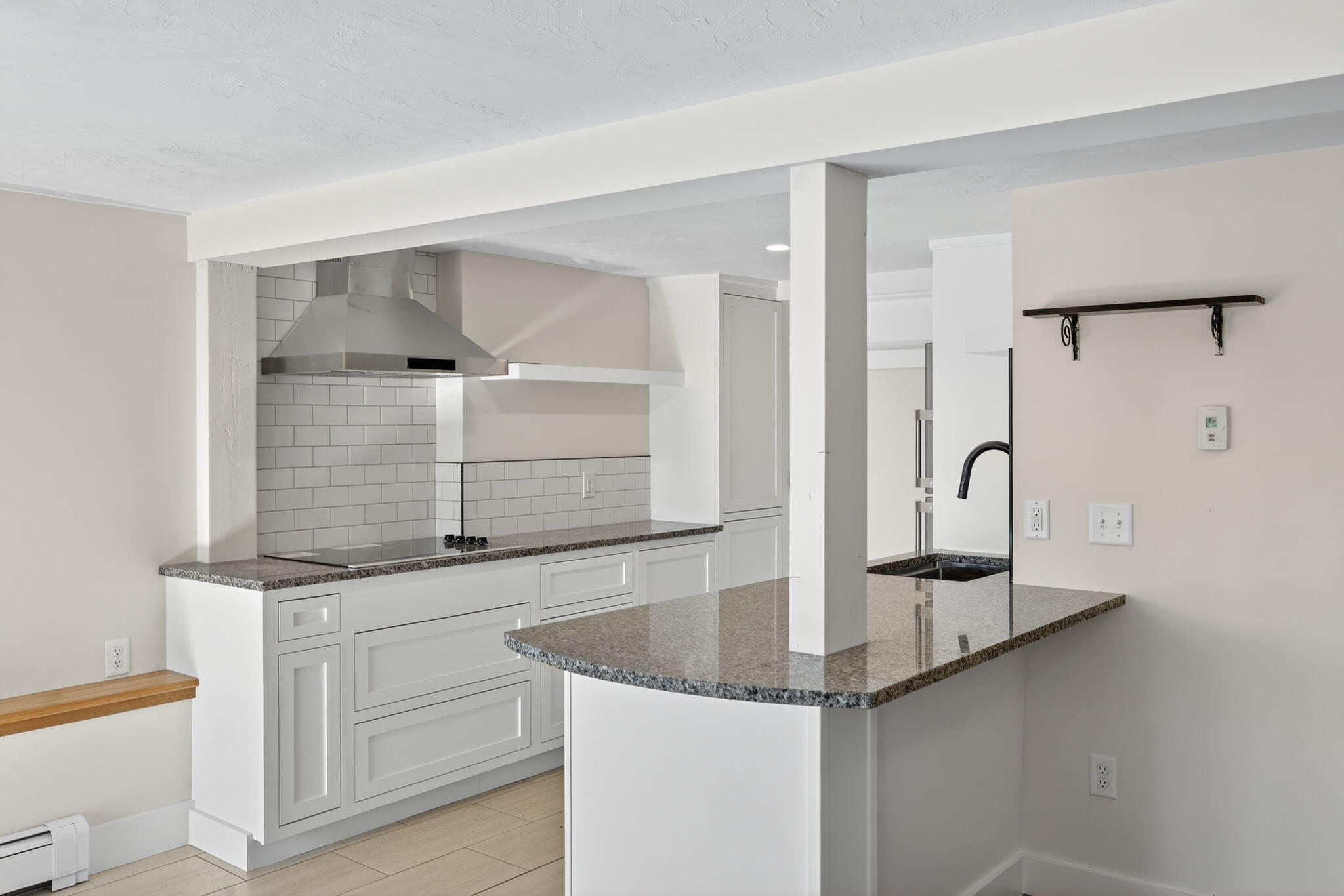 704 State Highway Eastham, MA 02642 - Photo 17 of 26 a kitchen with granite countertop a sink and cabinets