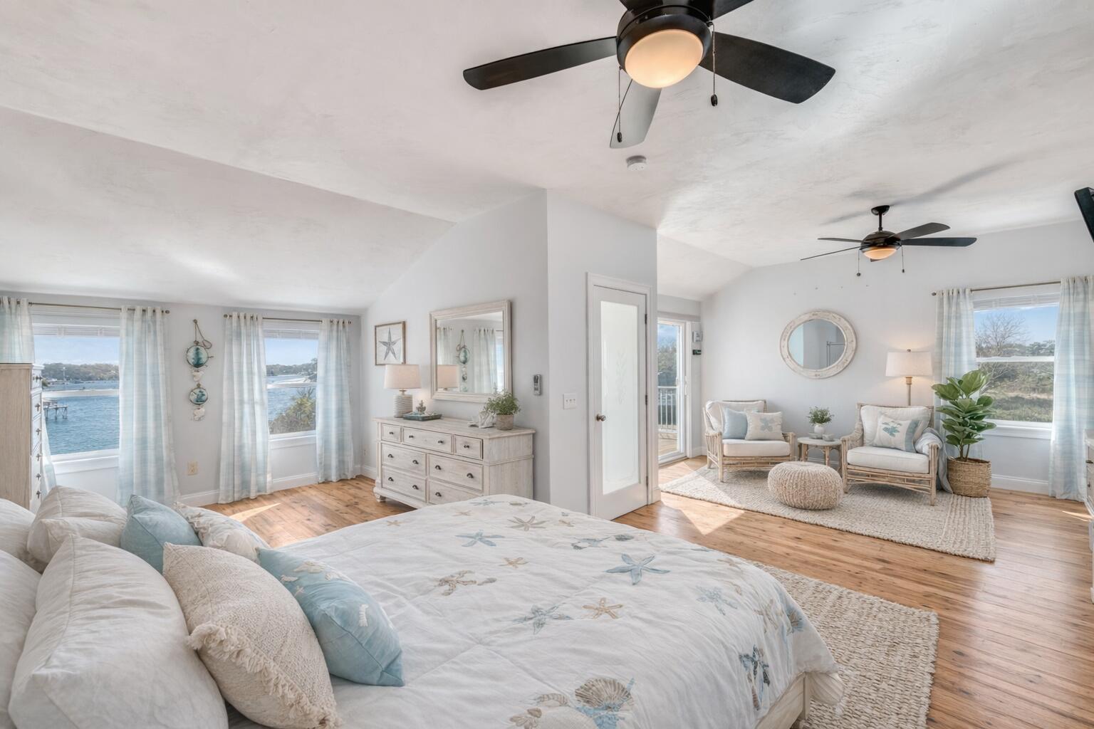 704 State Highway Eastham, MA 02642 - Photo 8 of 26 a bedroom with a large bed and ceiling fan