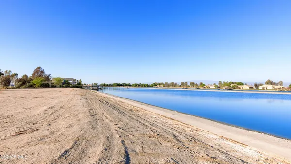 a view of a lake with chairs