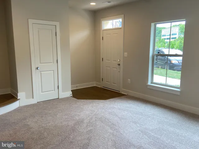 an empty room with windows and closet