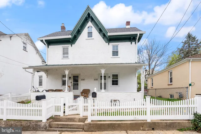 a view of a white house with large windows