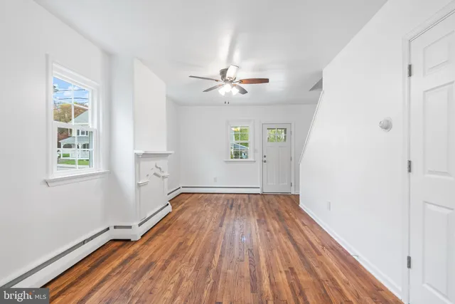 wooden floor in an empty room with a window