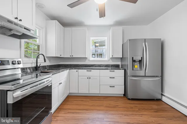 a kitchen with a refrigerator stove and sink