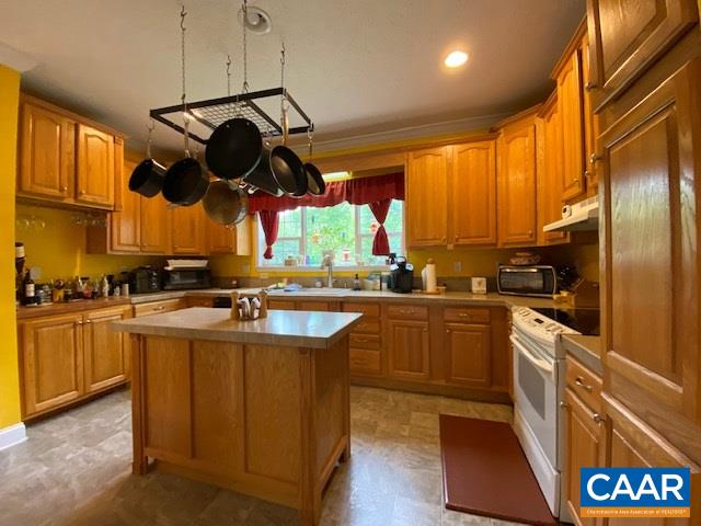 404 Rocky Road Stanardsville, VA 22973 - Photo 14 of 33 a kitchen with stainless steel appliances granite countertop a sink a stove and a refrigerator