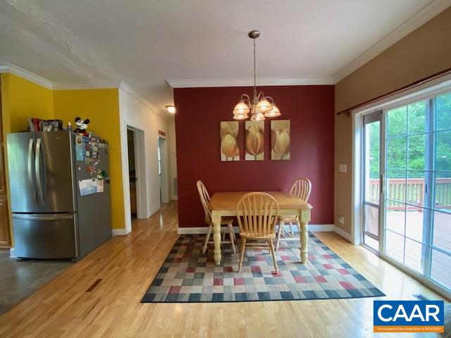 404 Rocky Road Stanardsville, VA 22973 - Photo 15 of 33 a dining room with furniture a chandelier and wooden floor