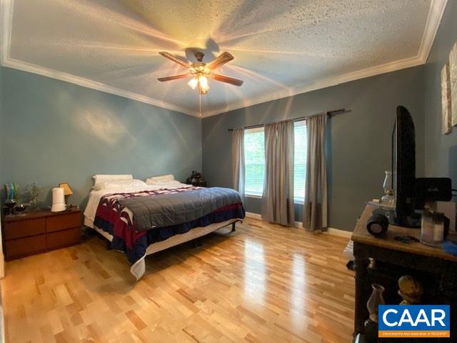 404 Rocky Road Stanardsville, VA 22973 - Photo 22 of 33 a bedroom with a bed and a flat screen tv